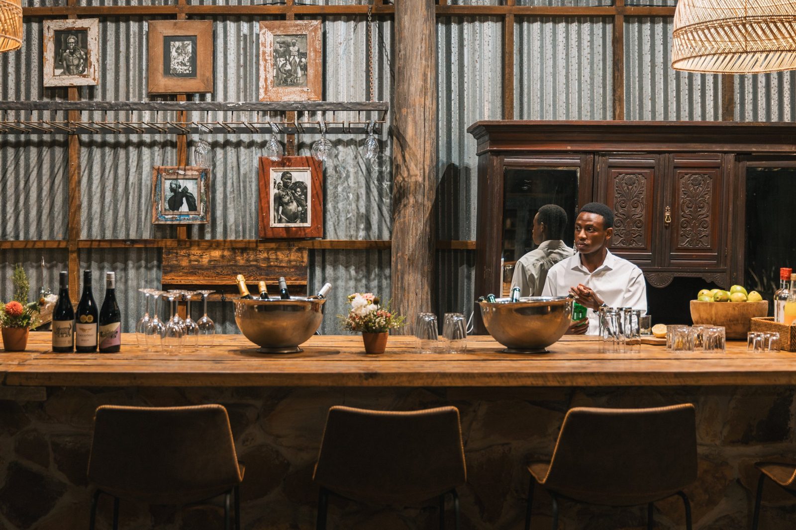 Still from a lodge film: barman at a rustic bar