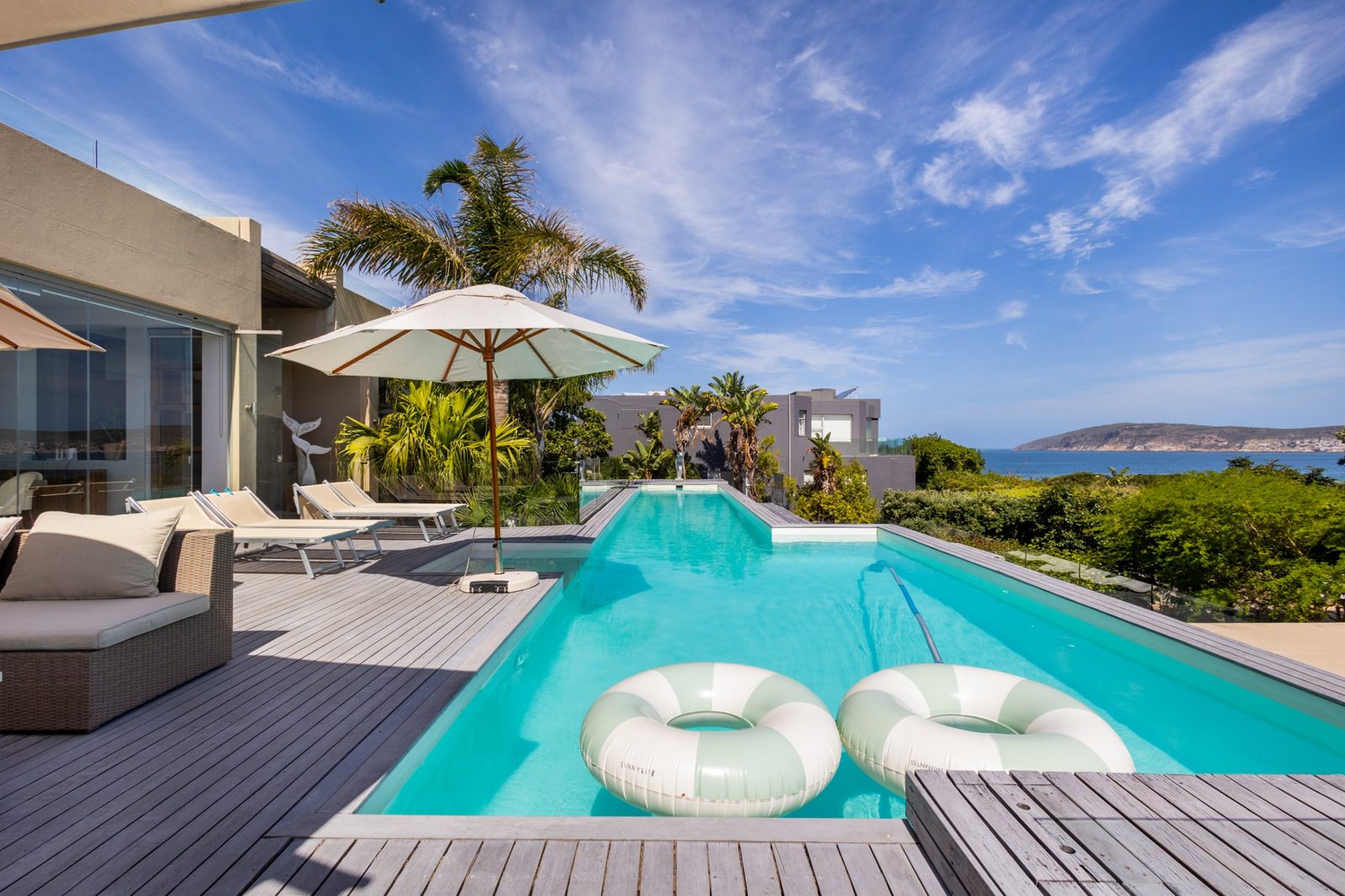 Still from a property walkthrough: pool deck with sea views